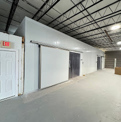 Walk-in cooler and freezer sliding doors installed in a warehouse